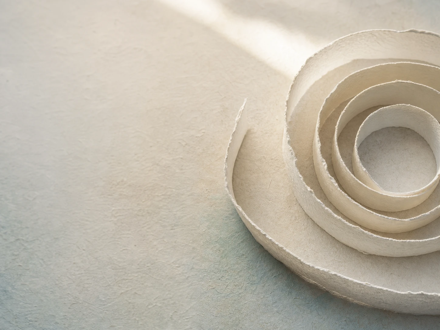 Layered paper loops opening toward the light